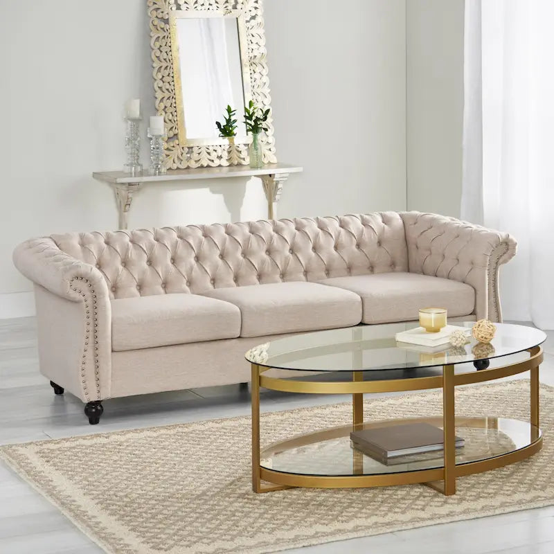 Beige tufted three-seater sofa, adorned with rivets