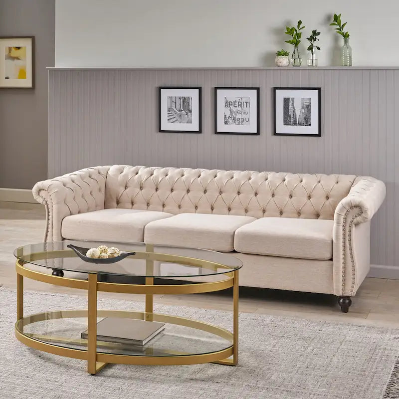 Beige tufted three-seater sofa, adorned with rivets