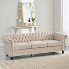 Beige tufted three-seater sofa, adorned with rivets