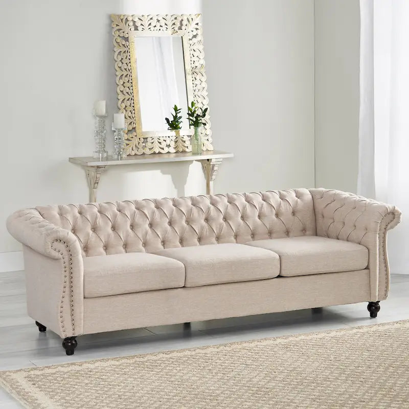 Beige tufted three-seater sofa, adorned with rivets