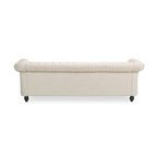Beige tufted three-seater sofa, adorned with rivets