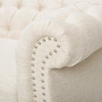 Beige tufted three-seater sofa, adorned with rivets